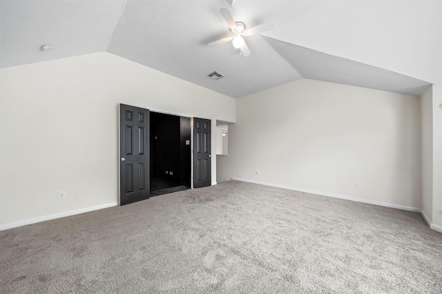 unfurnished bedroom featuring lofted ceiling, carpet, and ceiling fan