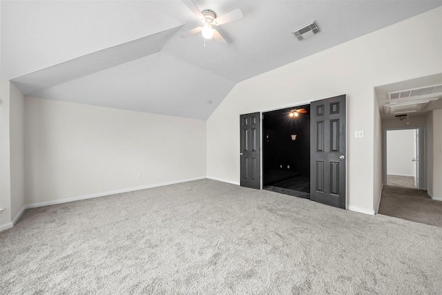 unfurnished bedroom featuring lofted ceiling, carpet floors, and ceiling fan