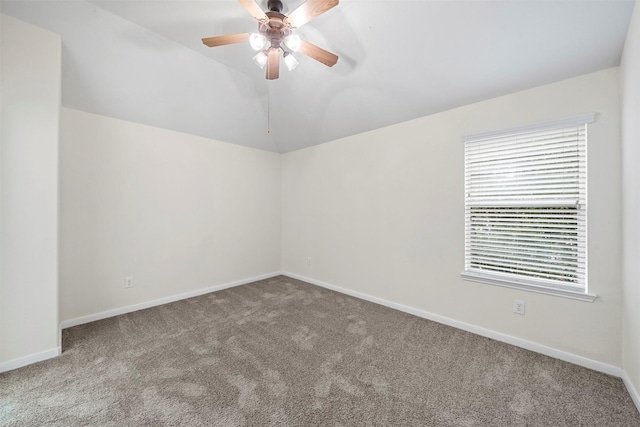 carpeted empty room featuring lofted ceiling and ceiling fan