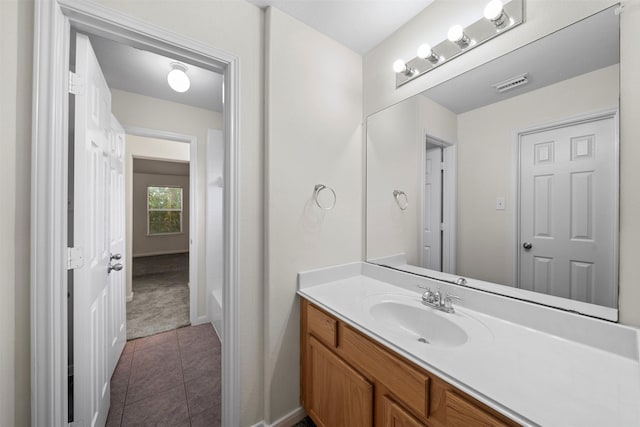 bathroom featuring vanity, a bathing tub, and tile patterned flooring