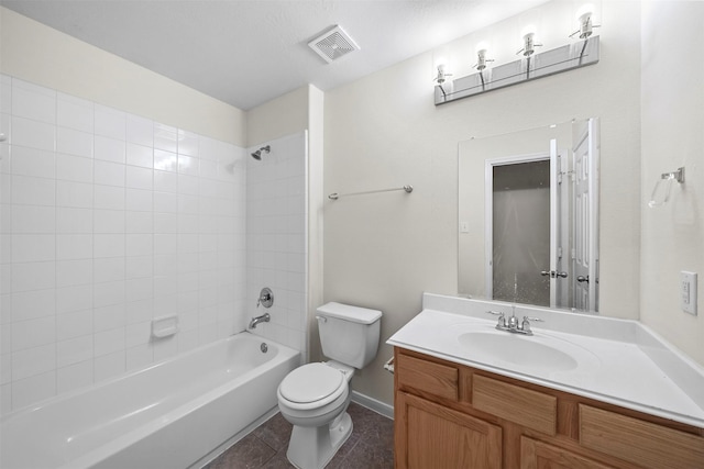 full bathroom featuring vanity, tiled shower / bath combo, tile patterned floors, and toilet