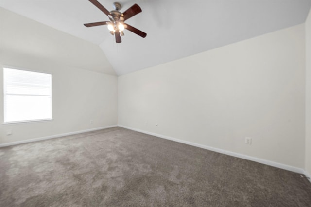 carpeted spare room featuring lofted ceiling and ceiling fan