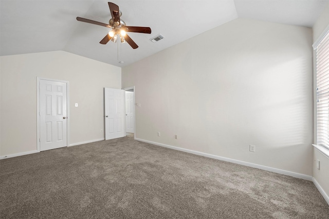 unfurnished bedroom featuring multiple windows, vaulted ceiling, carpet flooring, and ceiling fan