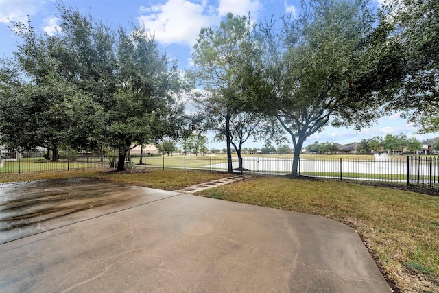 view of yard with a patio and a water view