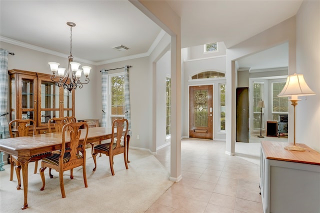 tiled dining space with an inviting chandelier and ornamental molding