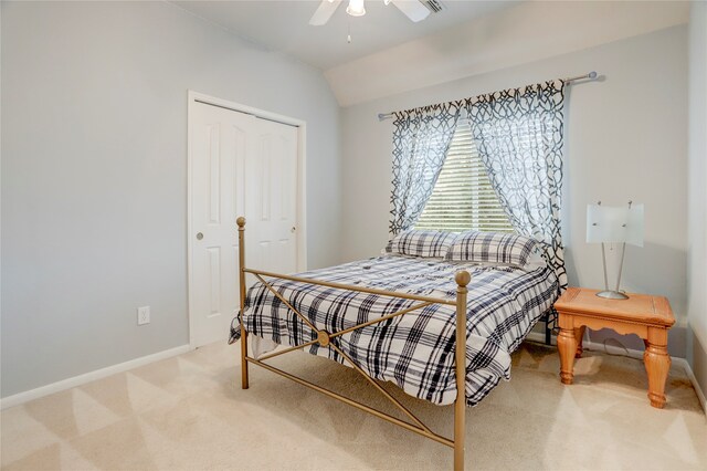 bedroom with carpet, ceiling fan, lofted ceiling, and a closet