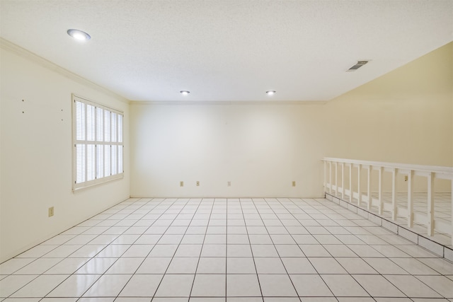 spare room with ornamental molding and light tile patterned floors