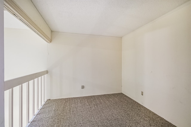 carpeted spare room with a textured ceiling