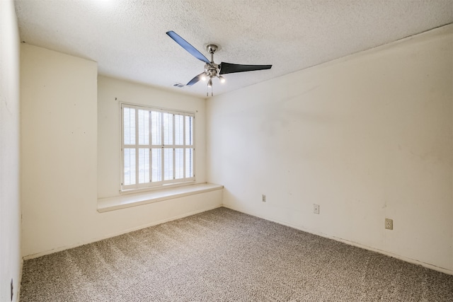 carpeted spare room with a textured ceiling and ceiling fan