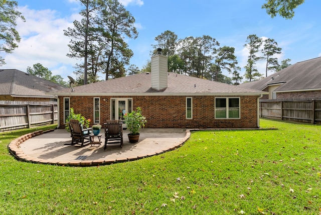 back of house with a patio area and a yard