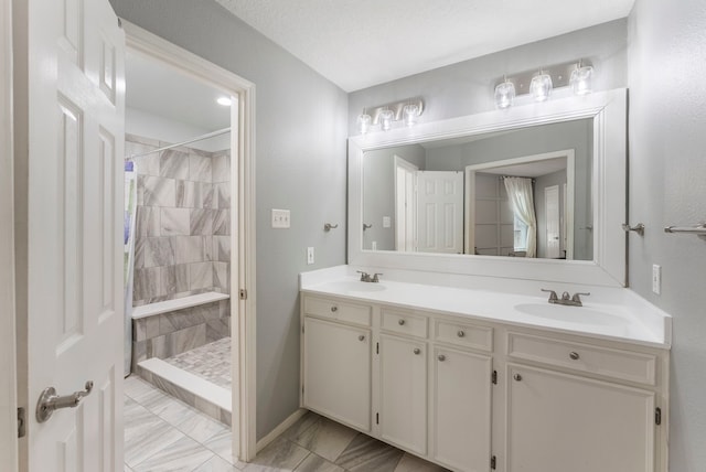 bathroom with vanity, a textured ceiling, and curtained shower