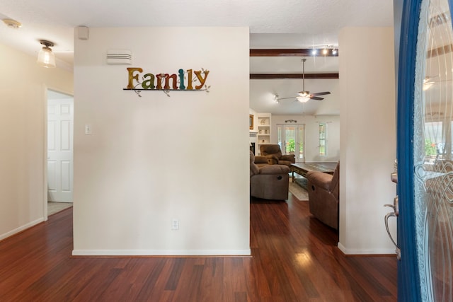 hallway featuring lofted ceiling with beams, a textured ceiling, and dark hardwood / wood-style flooring