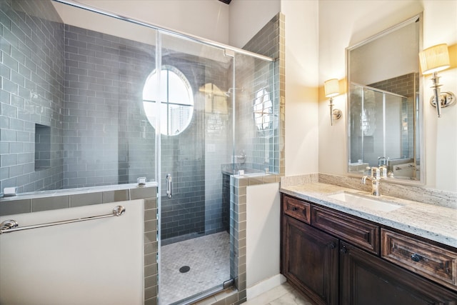 bathroom featuring vanity and a shower with shower door