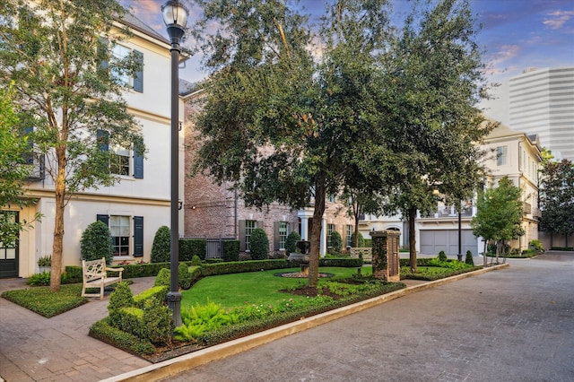 exterior space featuring a garage and a yard