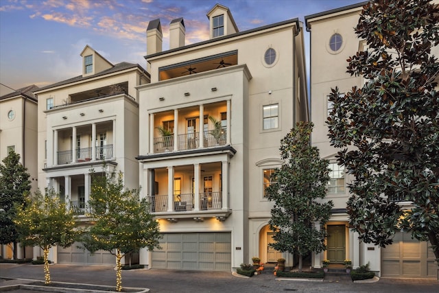 view of front of home featuring a balcony and a garage