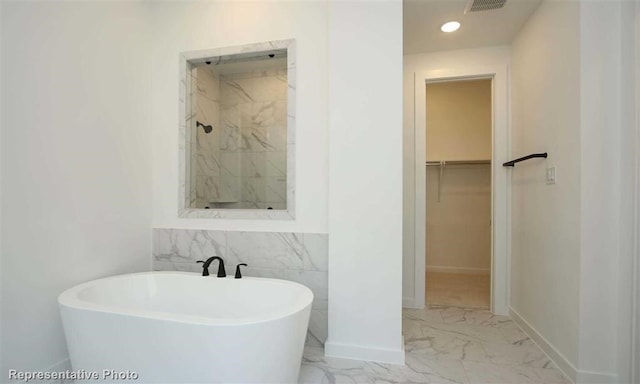 bathroom featuring separate shower and tub