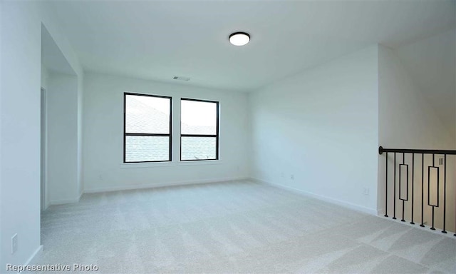 spare room with light colored carpet