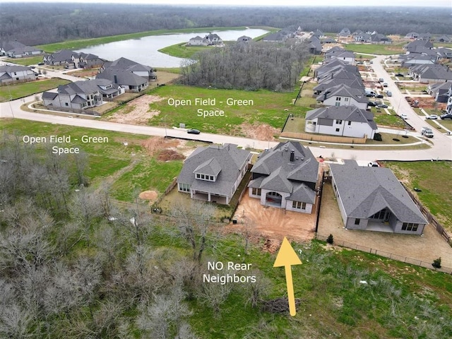 birds eye view of property with a water view and a residential view