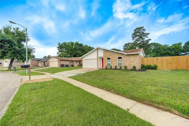 ranch-style house with a garage and a front yard