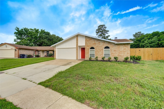 ranch-style house featuring a garage and a front lawn