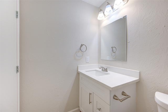 bathroom featuring toilet and vanity