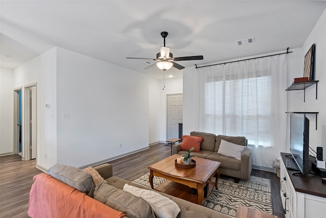 living room with dark hardwood / wood-style floors, a healthy amount of sunlight, and ceiling fan