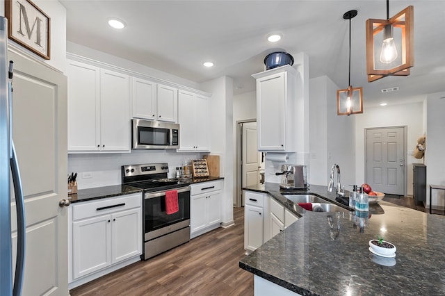 kitchen with white cabinets, stainless steel appliances, and hanging light fixtures