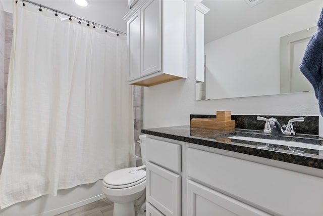 full bathroom with vanity, shower / bath combo, hardwood / wood-style flooring, and toilet