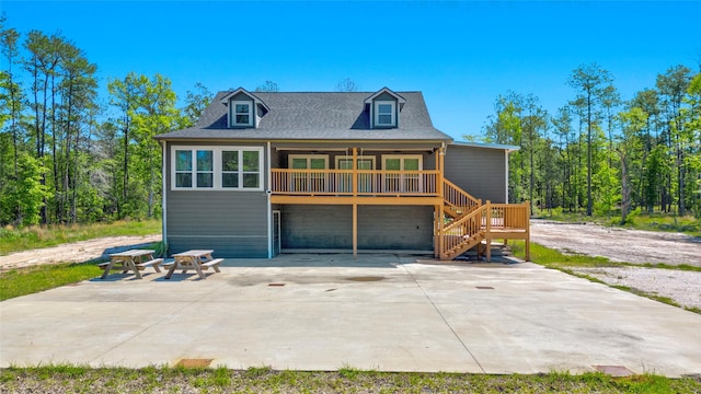 rear view of house with ceiling fan and a patio area