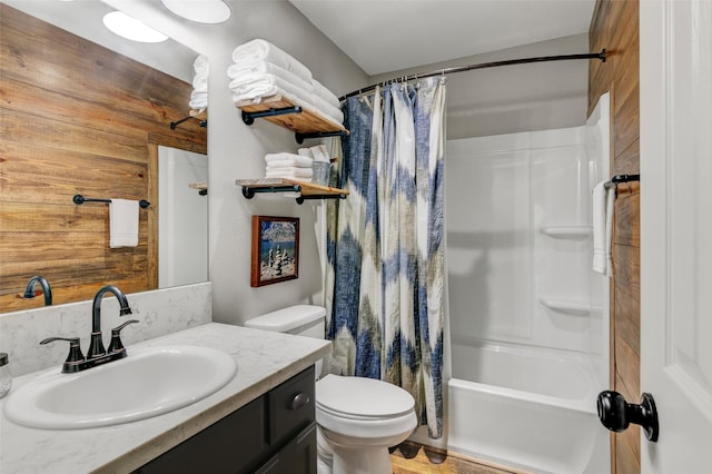 full bathroom featuring shower / bath combo, vanity, toilet, and wooden walls