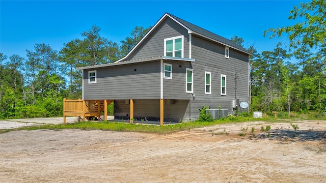 back of property featuring central AC unit