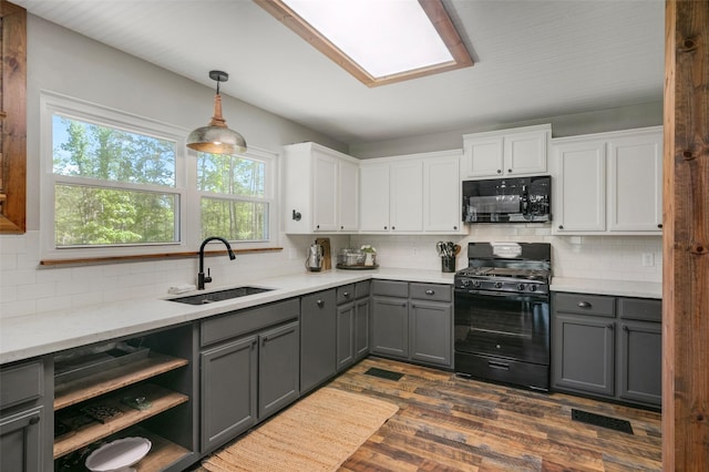 kitchen with sink, dark hardwood / wood-style floors, gray cabinets, white cabinets, and black appliances