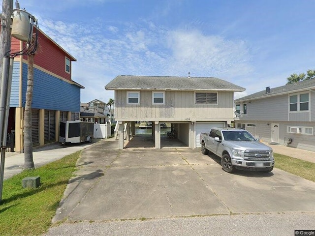 view of front of property featuring a carport and a garage