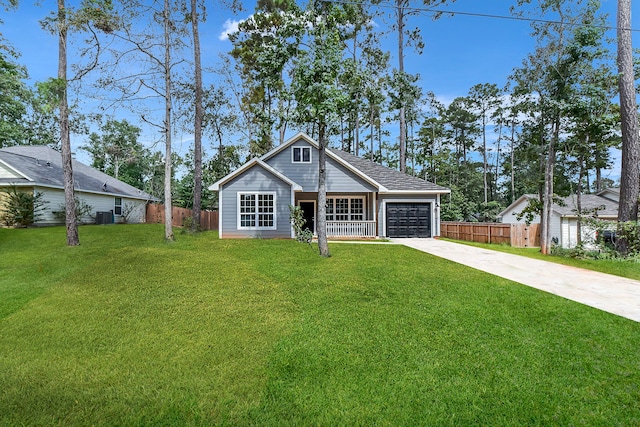 view of front of home featuring central AC unit, a garage, and a front lawn