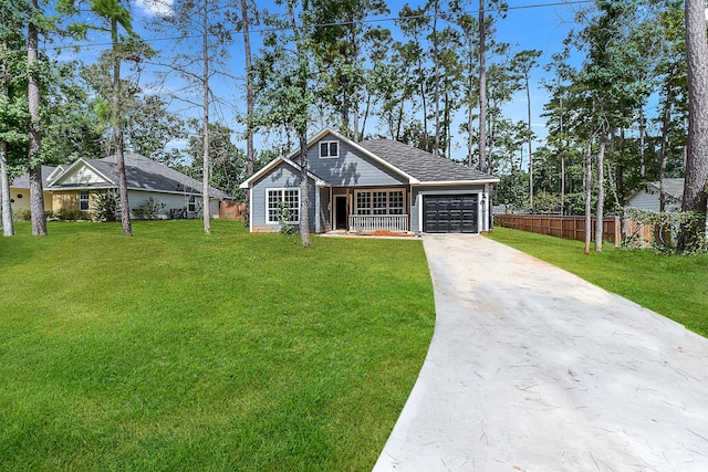 view of front of house featuring a garage and a front lawn