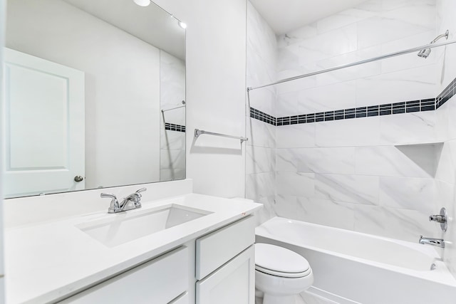 full bathroom featuring toilet, vanity, and tiled shower / bath