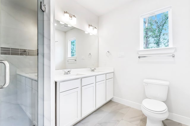 bathroom featuring walk in shower, vanity, toilet, and a healthy amount of sunlight