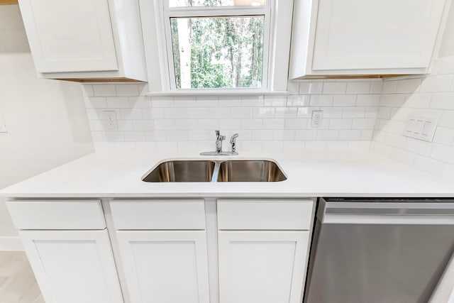 kitchen with white cabinetry, stainless steel dishwasher, and sink