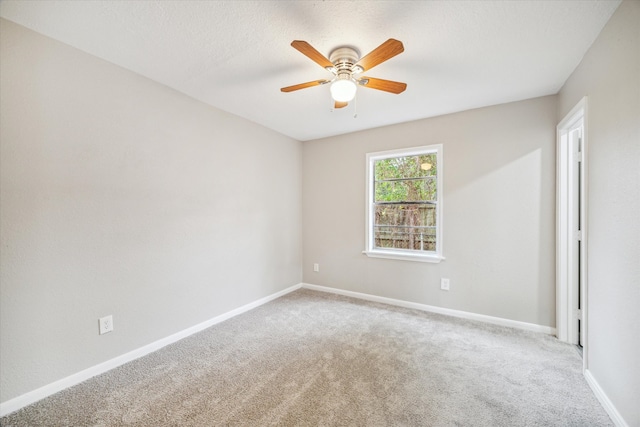 empty room with carpet flooring and ceiling fan