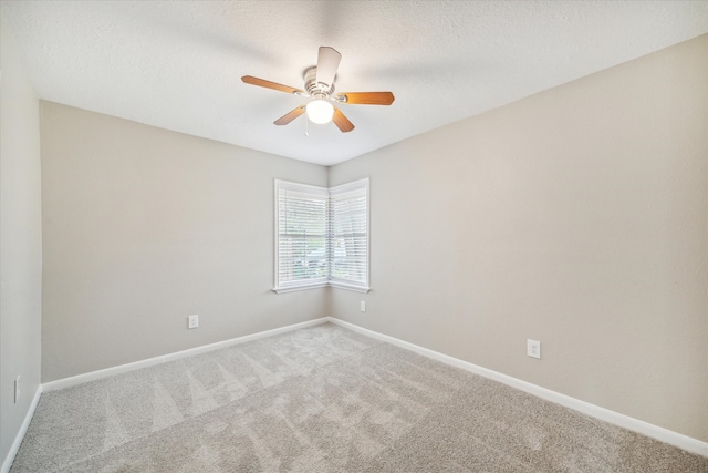 carpeted empty room with a textured ceiling and ceiling fan