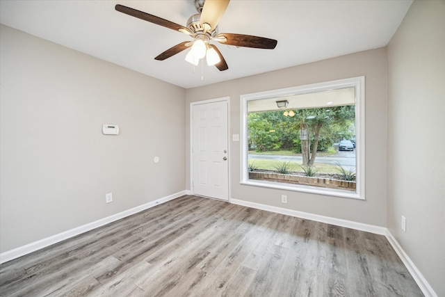 unfurnished room featuring light hardwood / wood-style floors and ceiling fan