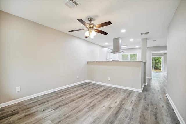 unfurnished living room with hardwood / wood-style floors and ceiling fan