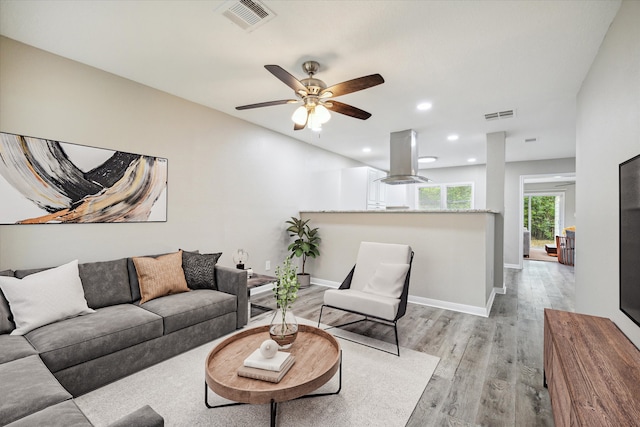 living room with light wood-type flooring and ceiling fan