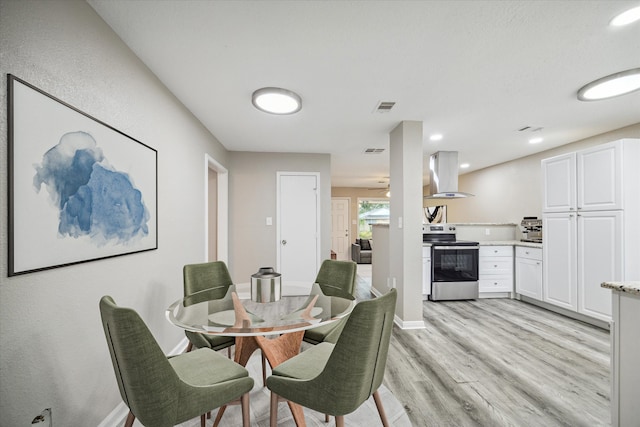 dining space with light hardwood / wood-style floors