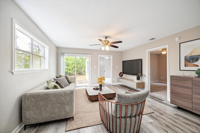 living room featuring ceiling fan and light wood-type flooring