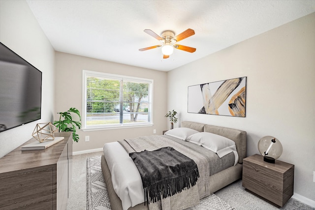 bedroom featuring light colored carpet and ceiling fan