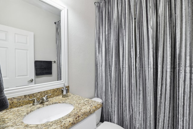 bathroom featuring toilet and vanity