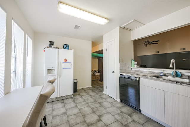 kitchen with black dishwasher, sink, white refrigerator with ice dispenser, and ceiling fan