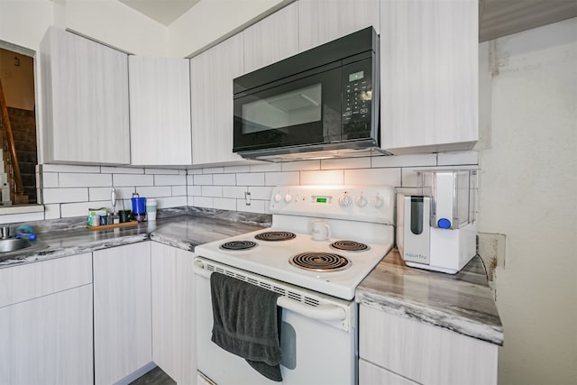 kitchen featuring white electric range and backsplash