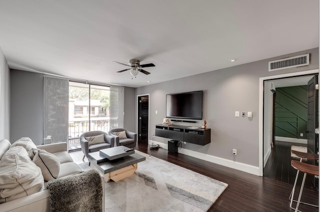 living room with dark wood-type flooring and ceiling fan